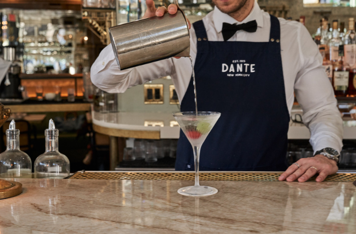 Bartender pouring a drink at the iconic Caffe Dante