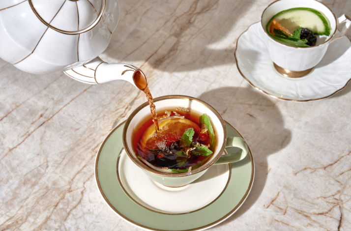 Pimm's Cup cocktail being poured into a teacup at Caffe Dante