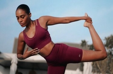 Photo of Adrienne Everett, an Alo wellness architect and founder of HWH Studio, doing yoga.