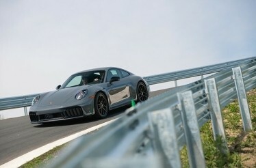 A Porsche 911 on a race lane during a drive experience on Porsche Experience Centre Toronto premises.