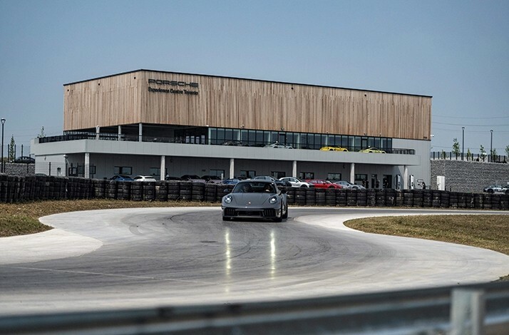 A Porsche 911 on a race lane during a drive experience on Porsche Experience Centre Toronto premises.