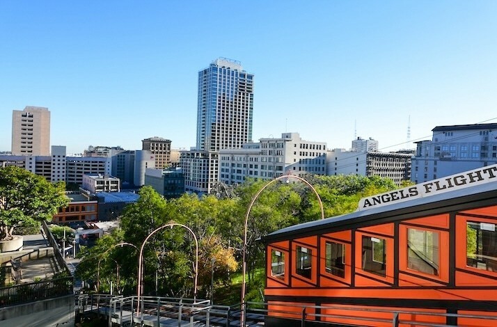 Angels Flight funicular with downtown LA skyline, part of the city’s design journey.
