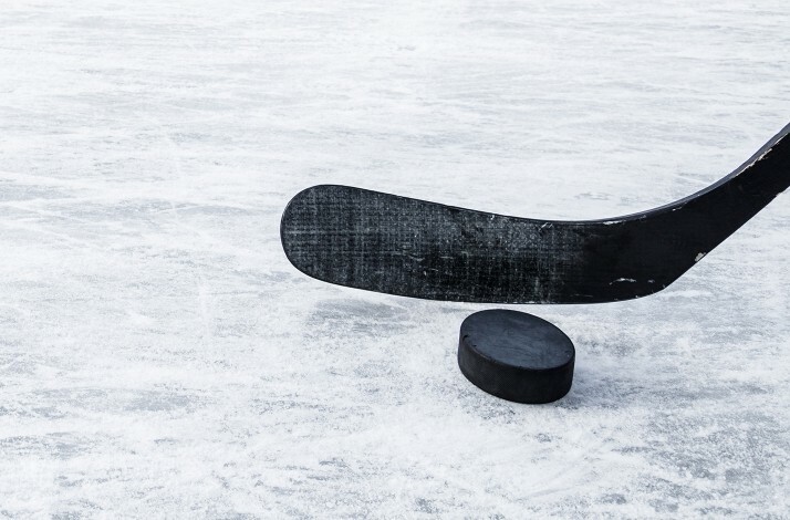 Promotional photo of a hockey puck and stick.