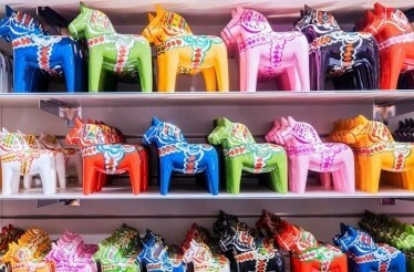 Shelves filled with vibrant, colorful, traditional Dala horses.