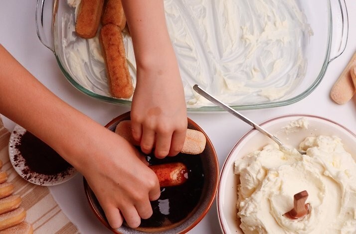 A child making tiramisu at a chef-led masterclass at Eataly Flatiron.