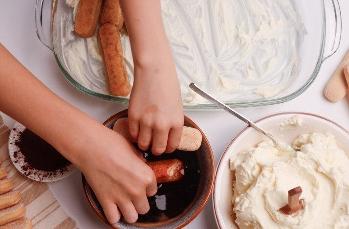 A child making tiramisu at a chef-led masterclass at Eataly Flatiron.