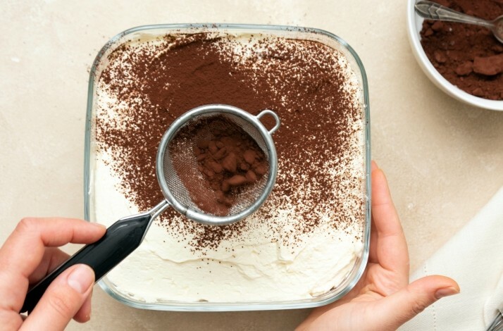 Someone making tiramisu from scratch