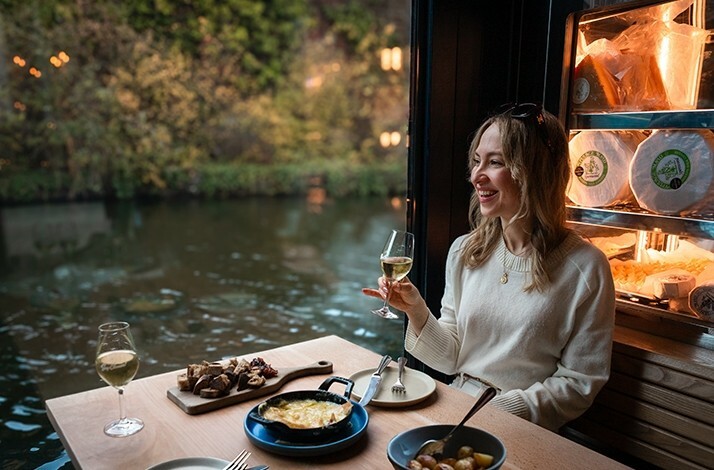 A person dining at The Cheese Barge a floating restaurant in London