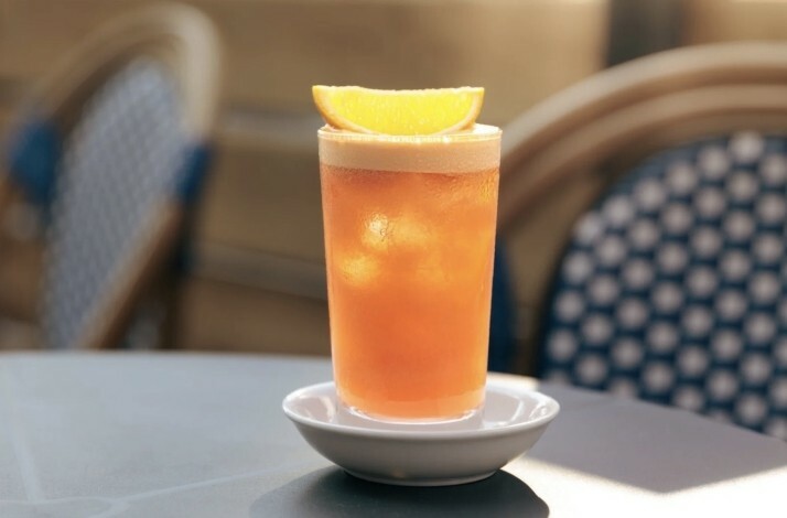 An Italian aperitivo cocktail decorated with an orange slice on top prepared at Dante bar in New York.