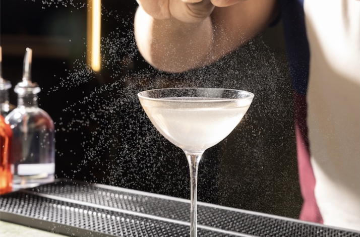 Cocktail preparation at immersive multisensory dining event.