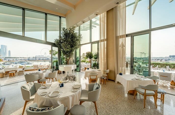 Elegant marina‑view dining room at L’Amo Bistro del Mare.