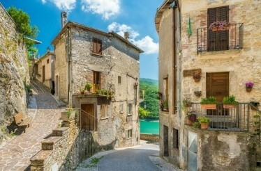 A narrow street with stone houses built along the street in  Castel di Tora, Italy.