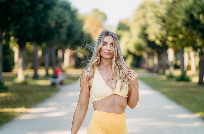 Fitness influencer Katja Believe posing on the street.