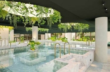 A pool at Soak Bathhouse Alexandria, featuring elegant design and surrounding greenery.