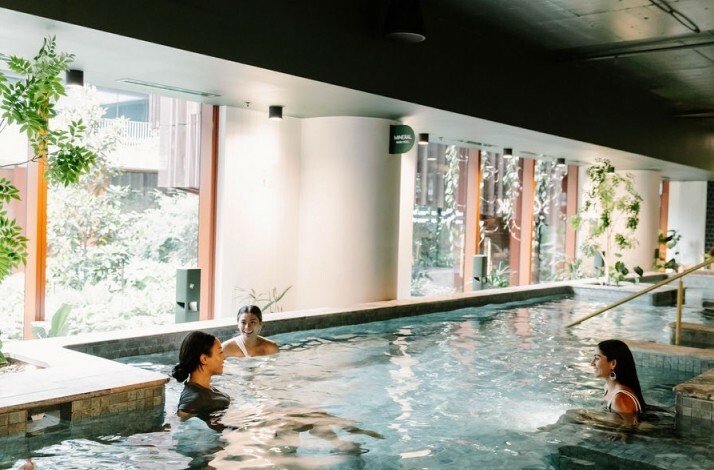People enjoying a hot magnesium pool at Soak Bathhouse Alexandria.