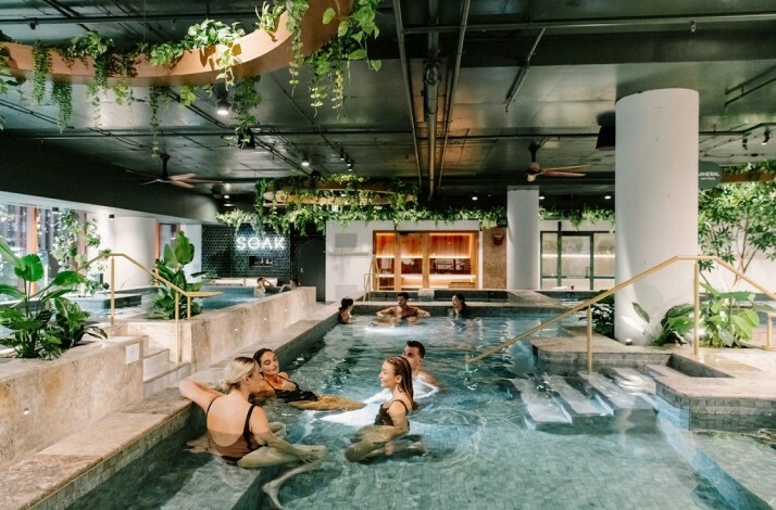 Groups of people enjoying the hot magnesium pools at Soak Bathhouse Alexandria.