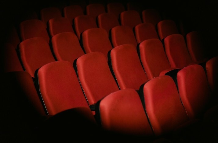 Seats at the Athens Conservatoire highlighted by a spotlight.
