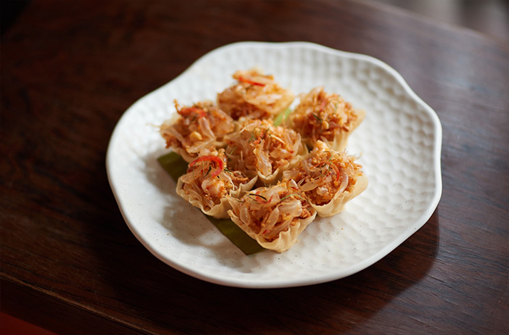 A plate of delicate Thai savoury bites served on a white dish.