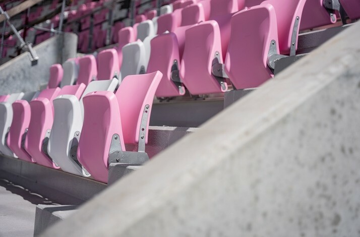 Close-up shot of pink and white stands, highlighting the vibrant seating arrangement.