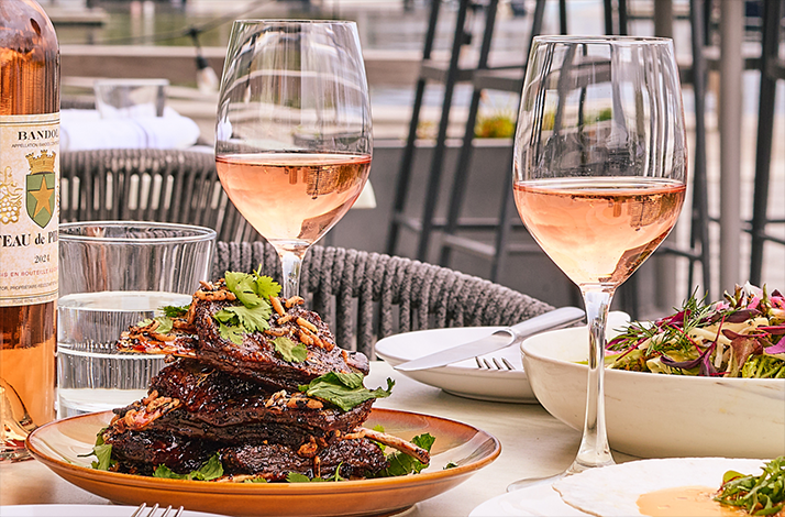 A table served with the dishes of the best New England produce paired with wine at Woods Hill Pier 4.