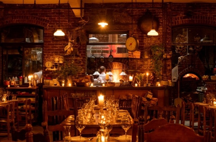 Rustic interior and open kitchen of restaurant Peasant.