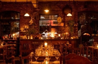 Rustic interior and open kitchen of restaurant Peasant.