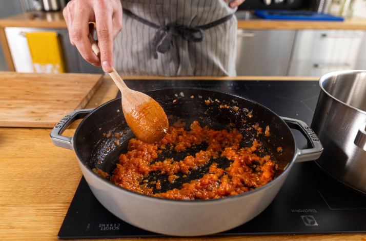 Chef sautés vegetables for a Dalmatian black risotto.