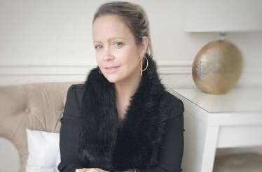 Portrait of fashion stylist Sharon Warten on a sofa