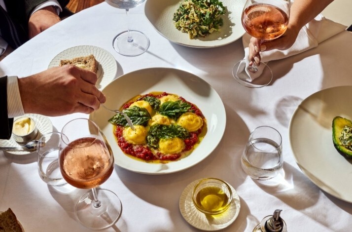 Main dishes paired with glasses of wine served at Marea Beverly Hills.