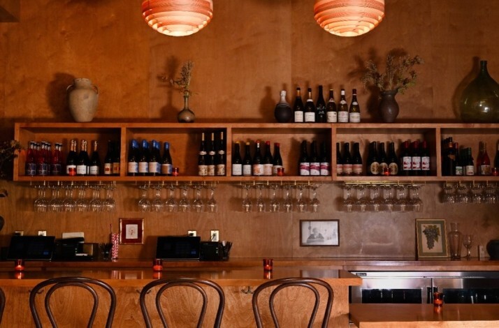 Bar counter at Ètra featuring collection of Italian wine.