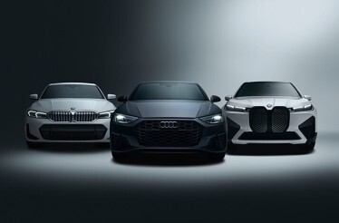 White BMW 5 Series, black Audi S5, and white BMW iX SUV facing forward in dramatic studio lighting, highlighting SIXT's Platinum-status vehicle selection.