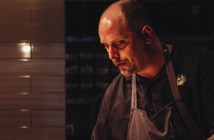 Chef Norman Fenton plating dishes at Cariño.