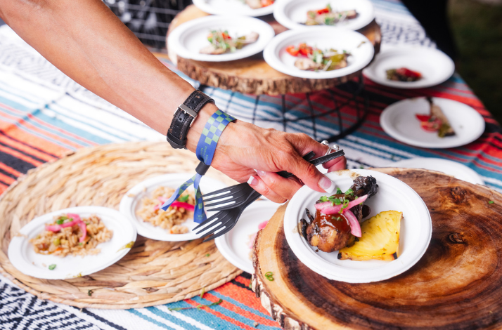 Foods being distributed on a small white plate at Austin Food and Wine Festival.