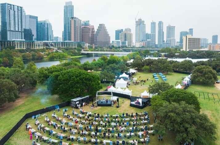 Aerial of Austin's skyline framing an upscale outdoor food festival.