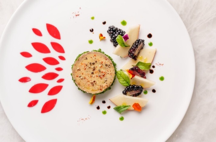 Artfully plated terrine with blackberries, pear slices, herbs, and red sauce accents at Le Jardinier Houston.
