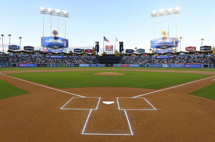 Dodger Stadium's field-level view from home plate, featuring the infield diamond, outfield scoreboard, and surrounding sponsor signage.