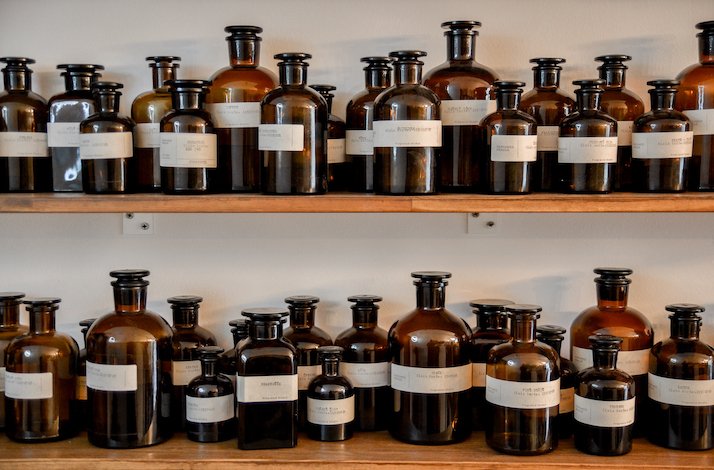 A shelf displaying an assortment of perfume bottles in various shapes and sizes at Perfumed Prague 