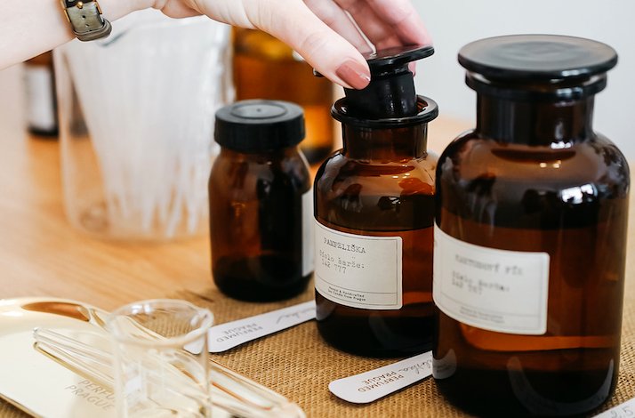 Women unlocks perfume bottle at  Perfumed Prague 