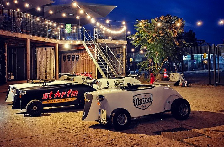 Various beautiful HotRod cars in the light of night garlands.