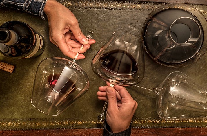 Close-up of wine glasses and a decanter on a leather mat at Little London