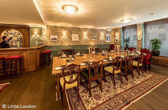 A large, elegant, candlelit table ready to serve at Little London steakhouse. © Little London