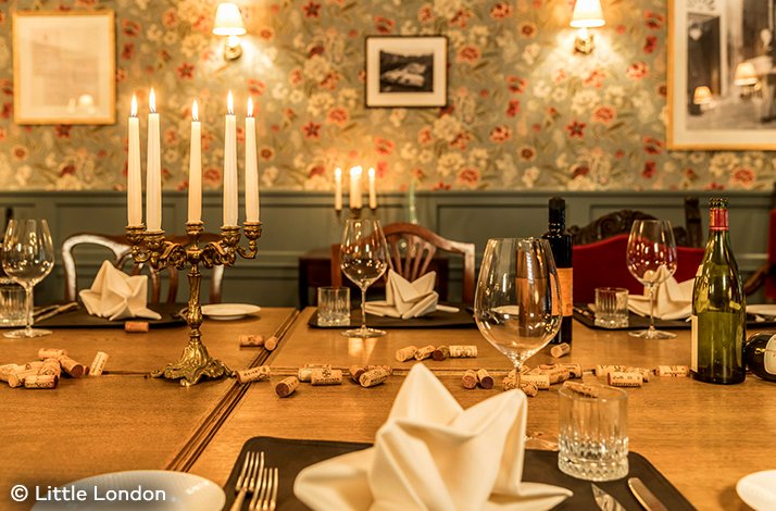An elegant, candlelit table ready to serve at Little London steakhouse. © Little London