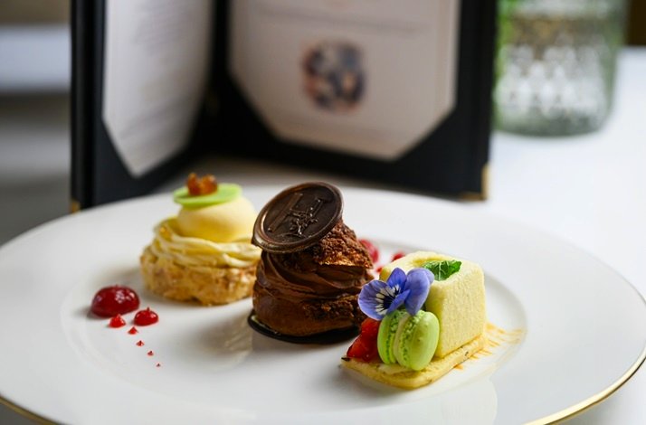 Three different types of desserts on a plate for visitors to Hayfield Manor.