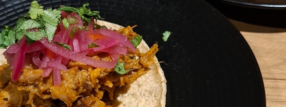 A special Mexican taco served in a black plate at Parrilla Ranelagh