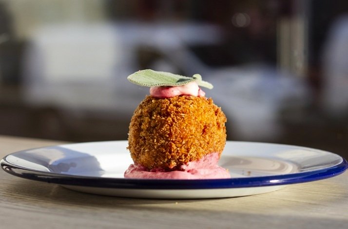 A small dessert on a plate, elegantly garnished with a delicate touch for added visual appeal.