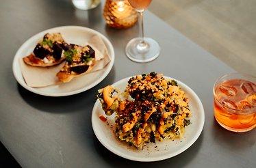 Close shot of two drinks and two dishes finely prepared at restaurant Tang Dublin.