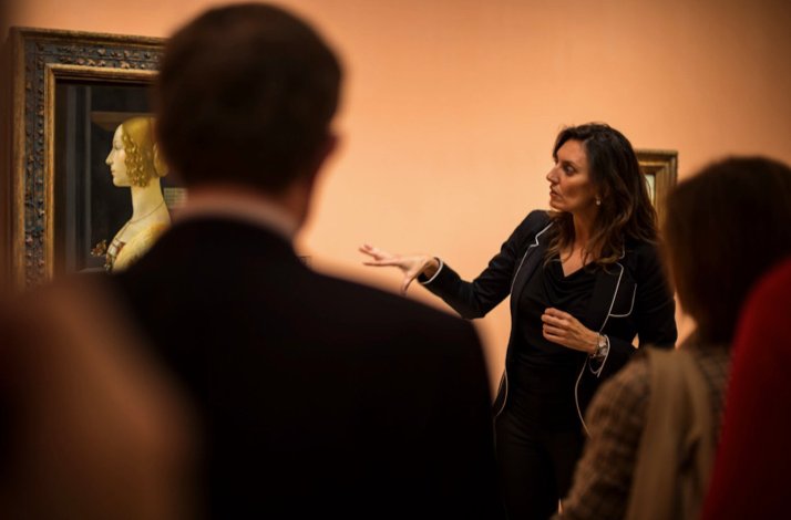 A guide presenting a painting to the visitors at Museo Nacional Thyssen-Bornemisza.