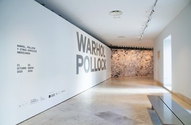 A Warhol/Pollock exhibition announcement on a wall of the Thyssen-Bornemisza National Museum hallway, Madrid, Spain.