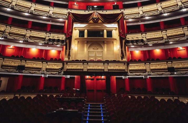 Elegant box seating highlighted by rich red tones and intricate gold details