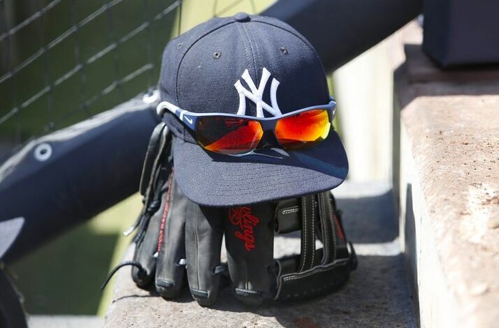 New York Yankees cap and glasses put on the baseball gloves.